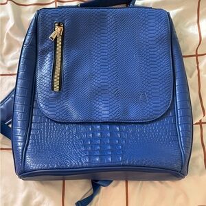 Chic Blue Textured Backpack with Gold Accent